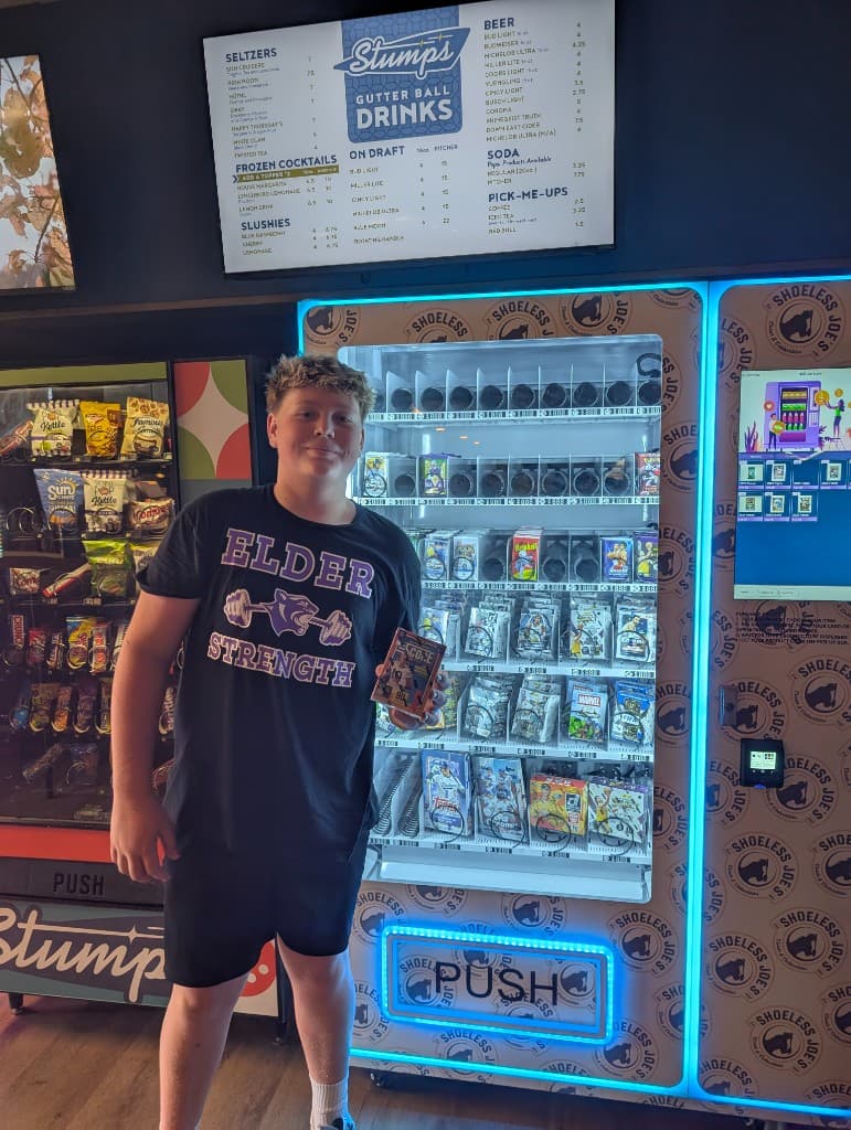 Customer at Shoeless Joe's sports card vending machine